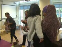 Mothers playing with young children at playgroup News Clip