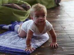 MS Shot of baby learning to crawl / Ubud, Bali, Indonesia Stock Footage