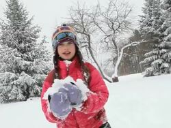MS ZI ZO Girl playing in snow during snow storm / Yarmouth, Maine, USA Stock Footage