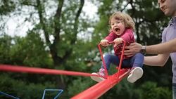Father and girl on playground Stock Footage