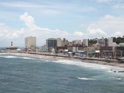 WS View of beach, lighthouse and skyline on sunny day / Salvador, Bahia, Brazil  Stock Footage