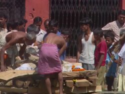 MS Men checking  wooden plank containing  body of deceased AUDIO / Kathmandu, Central Region, Nepal Stock Footage