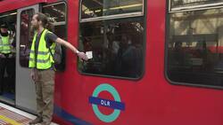 Extinction Rebellion protesters climb and glue themselves to a train at Canary Wharf News Clip