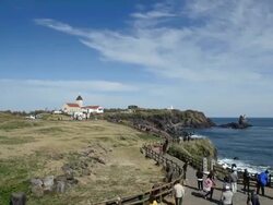 WS T/L View of Landscape of Seopjikoji ( Famous place for its scenics and Drama set at Jeju island ) Coastal Feature with tourists / Seogwipo, Jejudo, South Korea Stock Footage