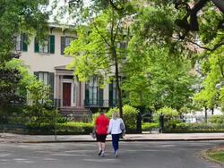 MS Shot of savannah Georgia street scene withand old homes and couple walking / Savannah, Georgia, United States Stock Footage