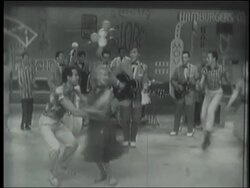B/W 1956 PAN zoom out Bill Haley + the Comets perform "Hot Dog Buddy Buddy" on TV special / Atlantic City Stock Footage