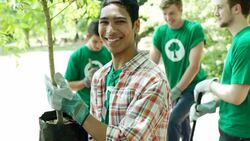 Portrait of environmentalist volunteer holding potted tree Stock Footage