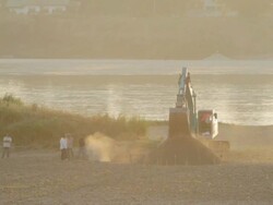 WS excavator working on bank of Mekong River / Vientiane, Laos Stock Footage