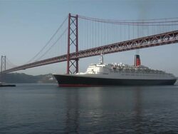 WS View of 25 de Abril bridge with Queen Elisabeth II ship moving on water / Lisbon, Portugal  Stock Footage
