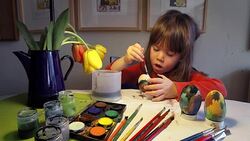 Learning Process-Little girl painting Easter eggs at home Stock Footage