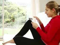 Digital tablet blond girl, red top Stock Footage