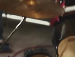 Handheld shot of a drummer rehearsing with his band. Stock Footage