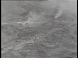 B/W 1950's high AERIAL of parachutes falling to ground / Korea / NO SOUND Stock Footage