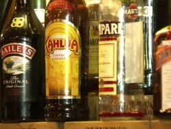 Bottles of Alcohol Arranged on Pub Shelves News Clip