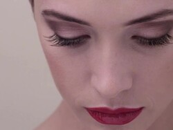 ECU close up on woman lifting head looking to camera and smiling Stock Footage