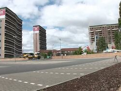 WS Two tall apartment buildings are demolished in controlled implosions using explosives and dissappear in huge cloud of dust / Pollokshaws, scotland, UK Stock Footage