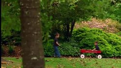 A boy pulls his brother in a wagon. Stock Footage