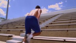 An athlete rests before running up a flight of stadium stairs. Stock Footage