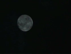 Full moon in cloudy night time lapse Stock Footage