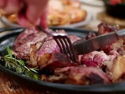 ECU R/F Hands cutting piece of steak with knife and fork / Barcelona, Catalunya, Spain Stock Footage