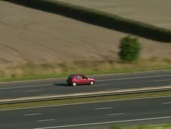 Low aerial view tracking shot zoom out following car on the M6 / Cumbria, England Stock Footage