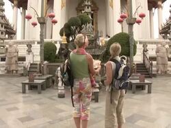 ZO WS Rear view of two women reading guidebook at Wat Phra Kaew (Temple of the Emerald Buddha), Bangkok, Thailand Stock Footage