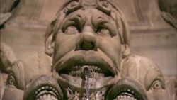 Water flows from a fountain shaped as a man's face. Stock Footage