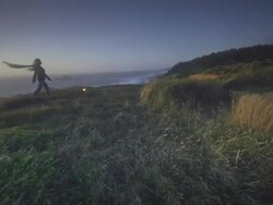 MS SLO MO TS Woman walking on trail overlooking ocean / Cape Blanco, Oregon, United States Stock Footage