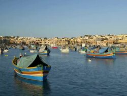 MULTI COLOURED FISHING BOATS AND TOWN Stock Footage