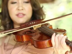 Asian female violinist practicing Stock Footage