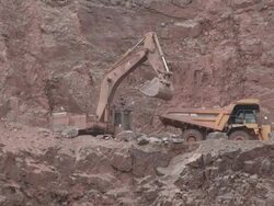 MS Excavator truck loading stone in another truck at quarry / Taben-Rodt, Rhineland-Palatinate, Germany Stock Footage