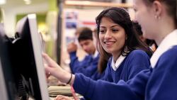 Girls talking and studying in school computer lab Stock Footage