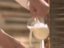 Chef pouring milk/cream onto flour. Stock Footage