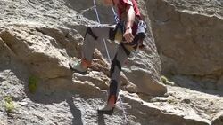 A young man rock climbing on a mountain.  - Slow Motion Stock Footage