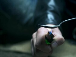 HD DOLLY: Heating A Spoon With Heroin Stock Footage