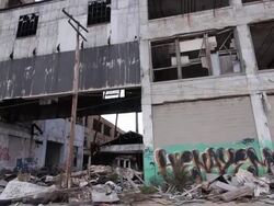 Exterior dolly view of abandoned auto assembly plant Stock Footage