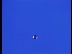 High Speed - Water drop falling through frame, blue background Stock Footage