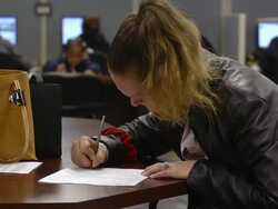 MS Hands of woman filling out forms seeking job at state run job center / Jackson, Michigan, United States  Stock Footage
