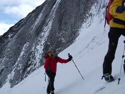 MS TS ZI T hikers passing on cammera and snow covered rock in the background / Namche,Namche Valley,Nepal Stock Footage