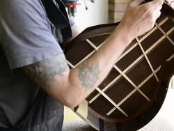 Craftsman 'Luthier' Nigel Forster making hand made Guitars Stock Footage