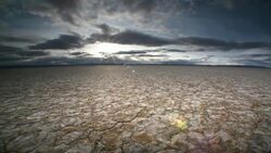 Dry, cracked earth and clouds Stock Footage