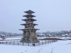 Snow scene of Jeongnimsajiocheungseoktap(Stone Pagoda, Korea National Treasure 9) at Jeongnimsa Temple Site Stock Footage