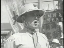 c1940: CHINA: U.S. MARINES: VS United States Marines lined during outdoor ceremony, drill sergeant calling (no SOT), soldiers at attention, marching through crowded street w/ Chinese people, children getting out of the way. Post World War II, Post-WWI Instructional Video