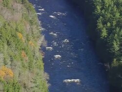 WS ARIEAL View of Stream of lake water in forest /Maine, United States Stock Footage