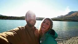 Cheerfull travellers taking selfies by lake Stock Footage