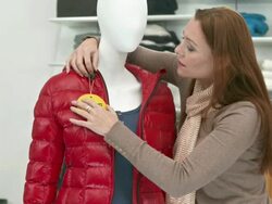 HD DOLLY: Putting A Sale Sign On Clothes Stock Footage