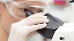 Scientist is using with microscope Stock Footage