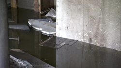 Debris floats in the basement of a flood damaged building. Stock Footage