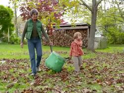 WS DS Grandmother and Grandson caring bag of leaves / Tivoli, New York, United States Stock Footage