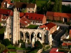 AERIAL old church ruins in residential area/ Arras, France Stock Footage